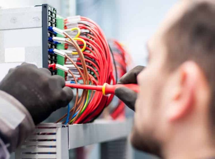 Electrician fixing wires — Electrical & Air-Conditioning in Logan, QLD